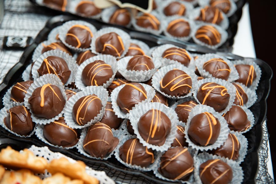 Chocolate truffles with gold drizzle on a Maravela's dessert table