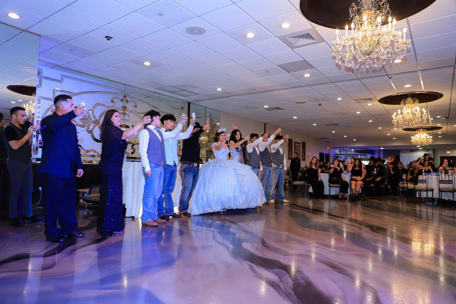 The full court dances on the reflective new floor at a Maravela's quinceañera