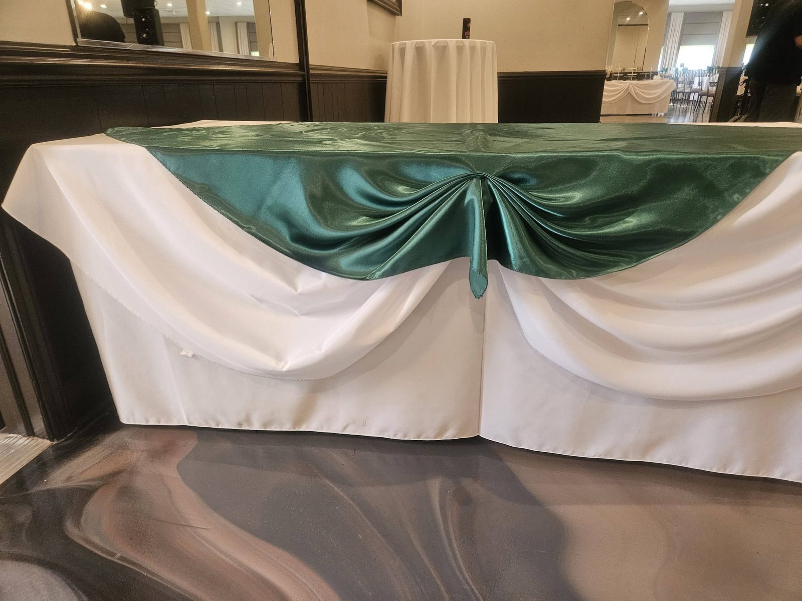Sweetheart table dressed in satin linens for a Maravela's reception