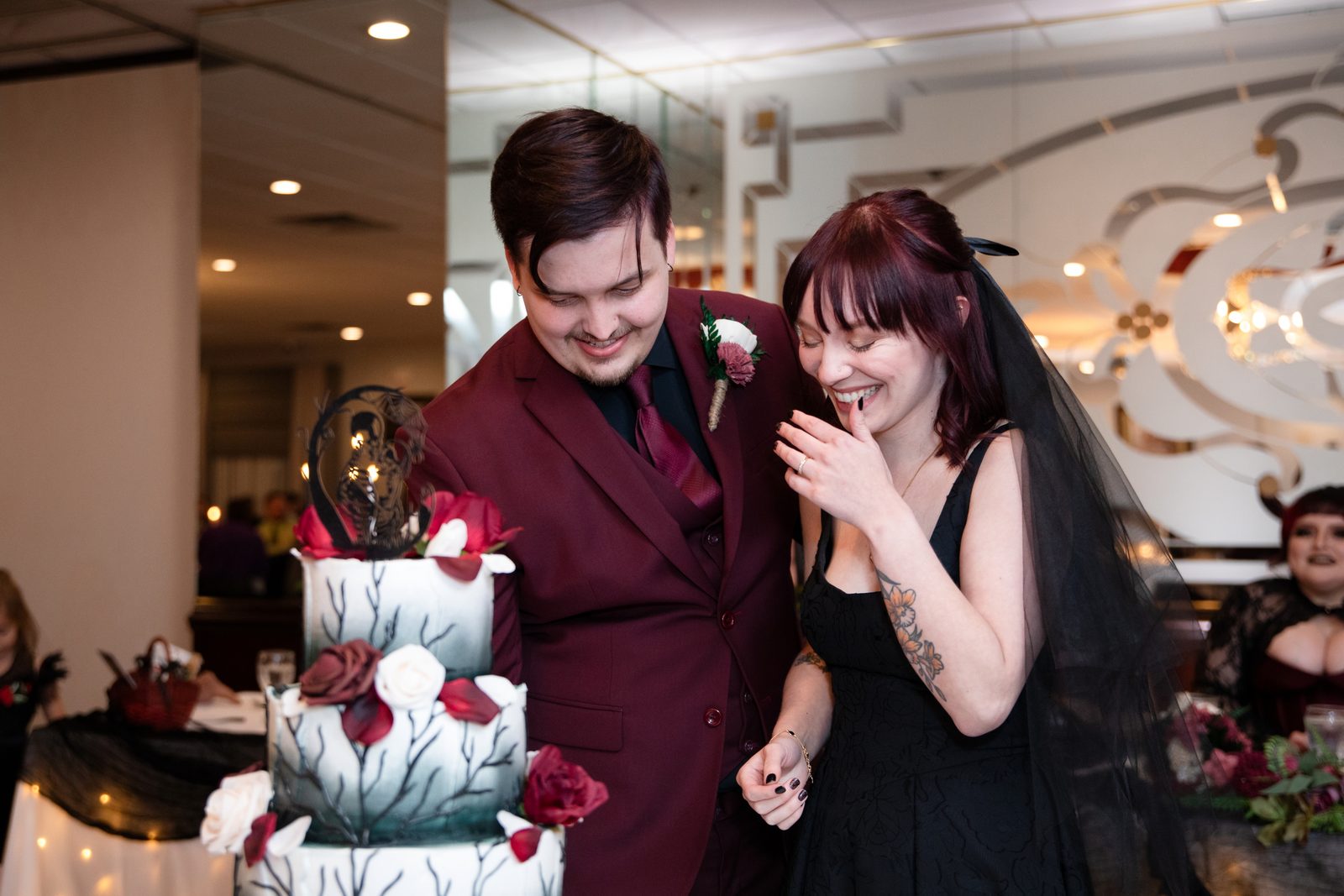 A couple laughs while cutting their wedding cake at Maravela's