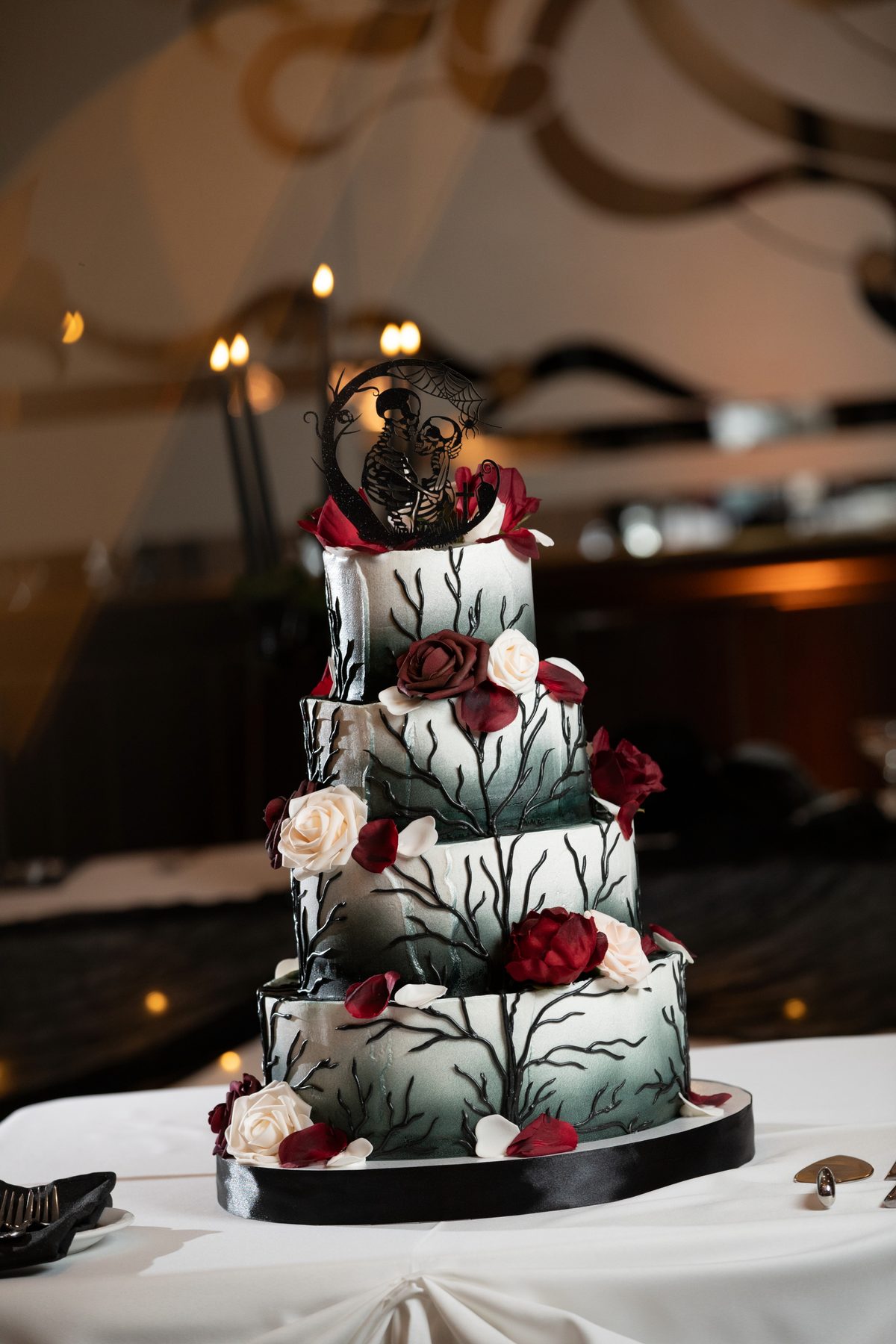 A hand-painted black-and-burgundy tiered wedding cake at Maravela's